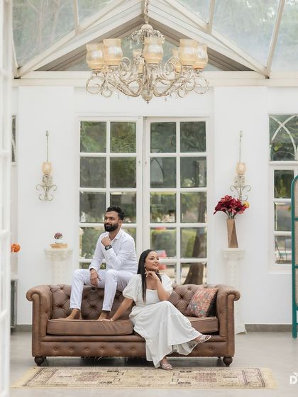 A wide shot showing the beautiful pre-wedding setup. The couple's look is coordinated, and her makeup is designed to be visible and flawless even from a distance.