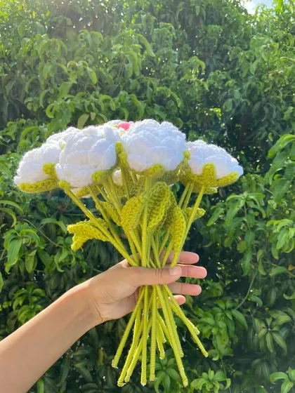 A side view of the pink-and-white rose bouquet, showing the long stems.