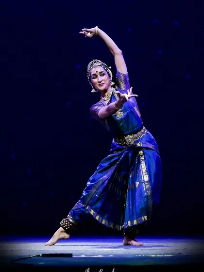 A graceful, arched pose from my Kuchipudi recital. The rich blue silk costume, with its traditional gold border, is an integral part of the visual storytelling.