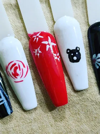 Some examples of my hand-painted designs on sample tips. I can create cute characters like teddy bears, elegant roses, simple hearts, or abstract patterns.