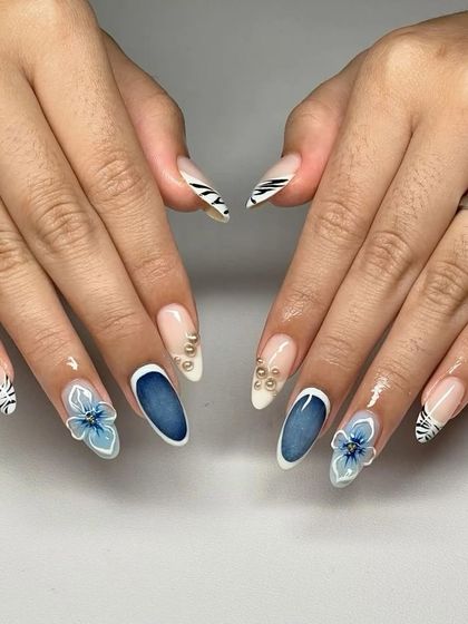 A chic and modern design for the monsoon season. This set features a mix of denim-blue nails, 3D flowers, and black-and-white zebra print for a cool, edgy vibe.