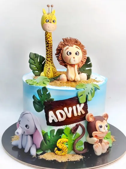 This jungle animal cake is overloaded with cuteness, featuring a hand-molded lion, giraffe, elephant, and monkey. All the figures on this chocolate truffle cake are edible and safe for kids.