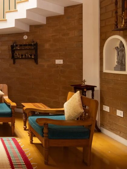 A detailed shot of the living space, showing a niche carved into the earth block wall for a sculpture, blending art and architecture.