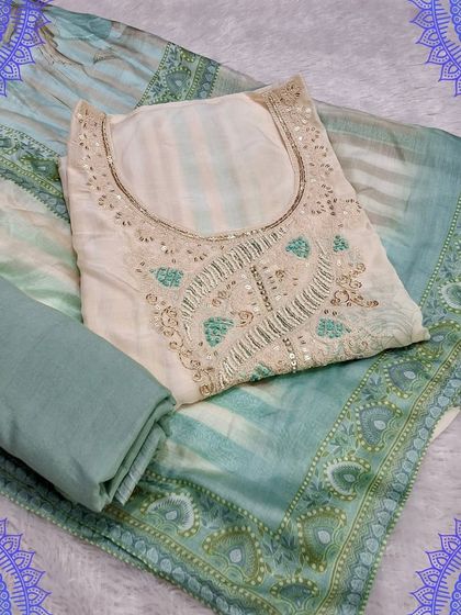 An elegant unstitched suit set in a pastel sea-green. The top has subtle embroidery, and the dupatta features a beautiful traditional border print.