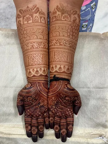 The deep, consistent stain of a traditional bridal mehendi with architectural motifs.