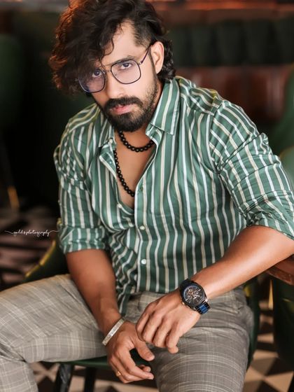 A collection of indoor portraits of an actor in a stylishly casual striped shirt. The moody lighting of the cafe setting adds a cinematic and modern feel, perfect for a character portfolio.
