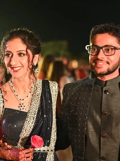 After party perfection. This couple's portrait captures the bride's chic reception look, featuring a dark blue saree, sparkling diamond jewelry, and a sophisticated makeup look that lasted well into the night.