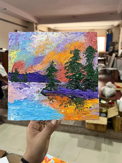 A student's colorful landscape painting, created using palette knives. Notice how the reflections in the water are captured with bold strokes and thick paint.