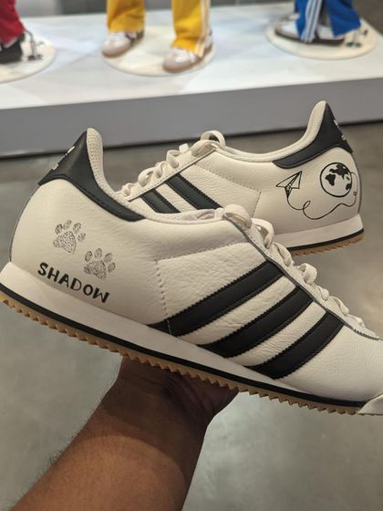 A simple and sweet custom Adidas sneaker I painted live at an event, featuring the name of a beloved pet, "Shadow," with paw prints.