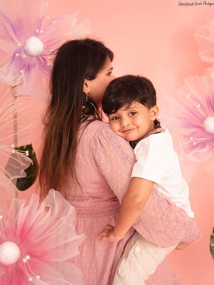 A quiet, loving hug from behind. This tender moment between a mother and son shows a different, more gentle side of their bond during their Mother's Day session.