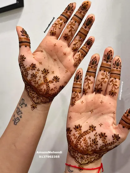 This delicate design features a branching lotus pattern on the palms, with simple bands on the fingers. It's a great way to have beautiful mehendi that complements a small tattoo.