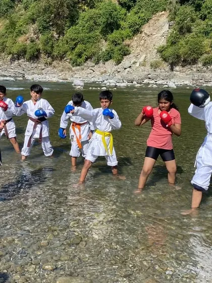 Teaching a kids' karate class right in the middle of a river. Training in water adds a new level of resistance and challenge, helping them build strength and balance in a fun way.
