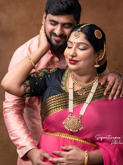 An intimate portrait of an expecting couple, dressed in elegant traditional attire, capturing the love and anticipation of their journey to parenthood.