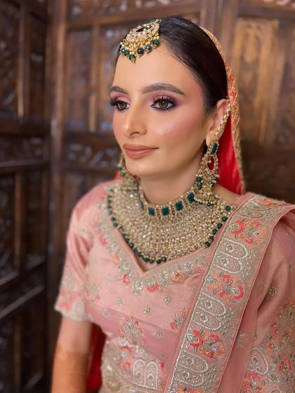 A portrait of my Anand Karaj Bride. The soft pink and green tones in her outfit and jewelry are complemented by a radiant, glowing makeup look.