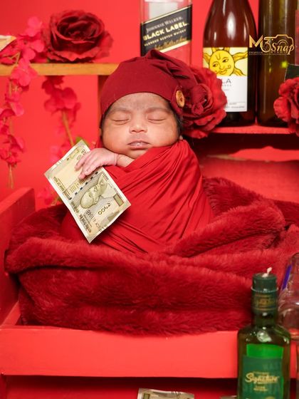 Adding a bit of fun with prop money. This "rich baby" theme is playful and always gets a laugh from the parents.