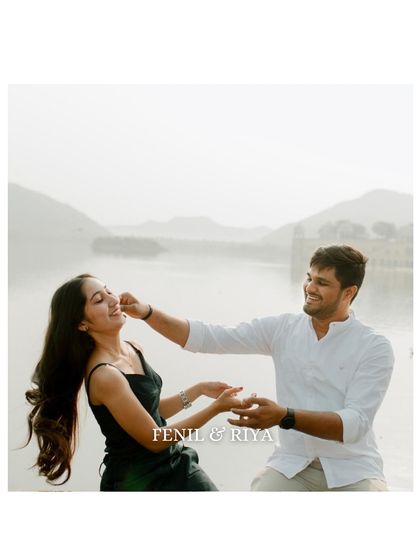 A playful and candid moment by the water. This photo captures the fun and lighthearted side of the couple's relationship, showing that their love is full of laughter.