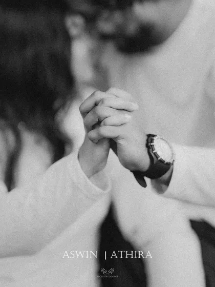 An intimate black and white close-up of the couple holding hands, a simple and powerful image of their bond.