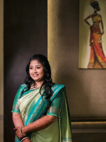 An elegant portrait of a bride in a beautiful green saree.