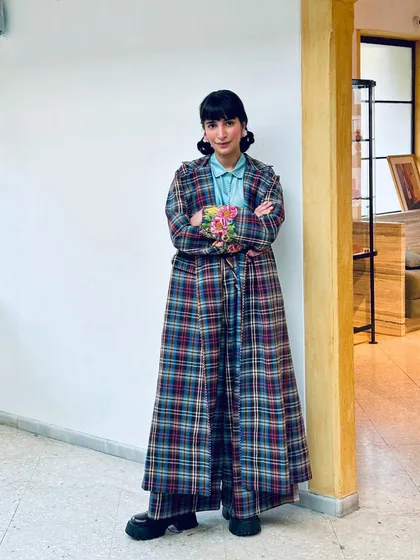 Another winter look, this time layering a plaid coat over wide-leg pants, with a pop of floral embroidery.