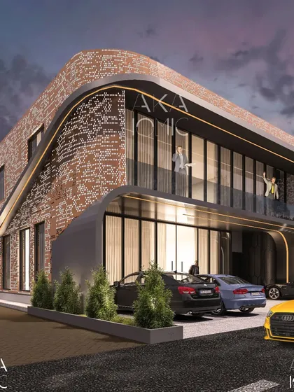 This office for a developer features a dynamic, curved facade that creates a covered entryway and an open balcony. The perforated brick pattern adds texture and visual interest to the building's exterior.