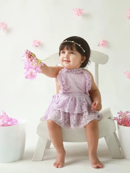 A sweet and simple floral theme. This little girl in a lavender dress, surrounded by pink blossoms, looks like she's in her own secret garden.