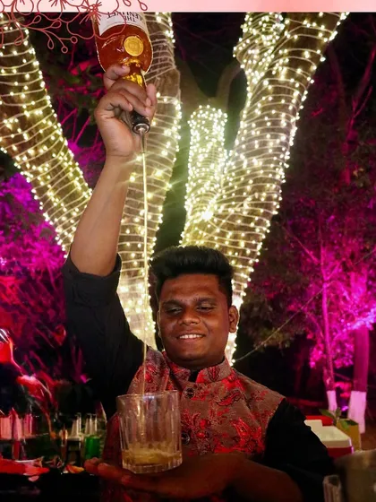 A high-pour of a classic whiskey drink, demonstrating the flair and confidence of our experienced bartending team.