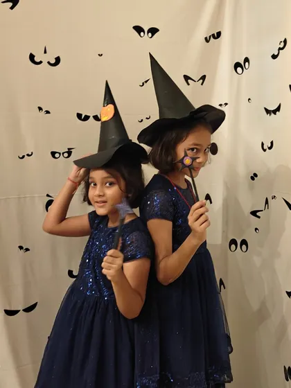 Double the trouble, double the fun. These two friends are perfectly coordinated in their witch costumes for our spooky and fun Halloween party at the club.
