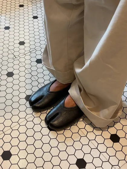 The DUPE Tabi flat in classic black leather, finding its place in a world of pattern and line. I designed this split-toe silhouette for those who appreciate a different perspective, blending traditional Japanese form with modern, everyday comfort.
