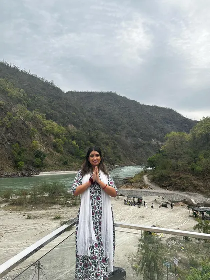 Standing in a prayer pose, offering gratitude for the serene beauty of Rishikesh. This is a place that truly nourishes the soul.