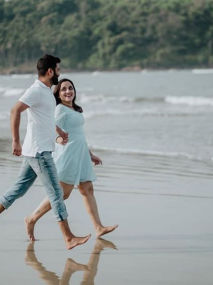 A dynamic shot of the couple running along the beach, capturing movement and the carefree spirit of their relationship.