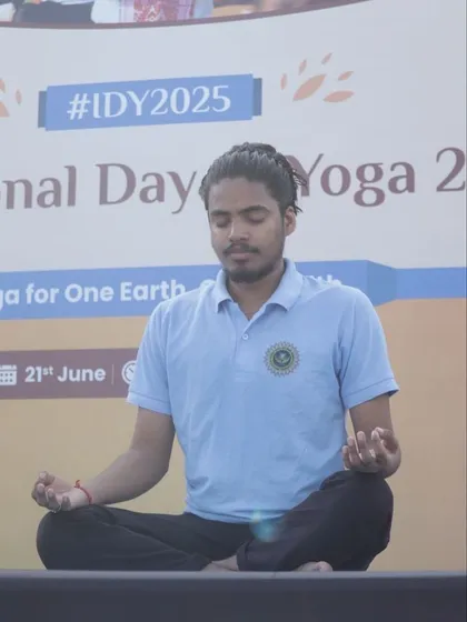 Leading a meditation session from the stage at an International Day of Yoga event.