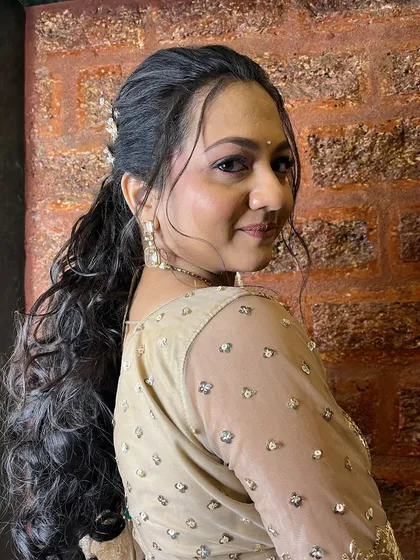 A view of the elegant ponytail hairstyle, adorned with butterfly clips, perfect for a sangeet.