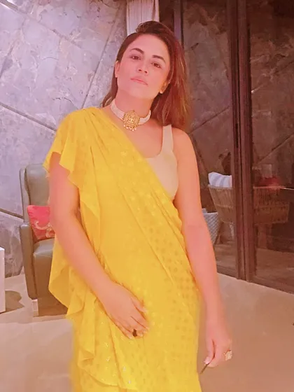 Another angle of the yellow saree look, demonstrating how the ruffled drape adds a modern, playful texture to the traditional garment.