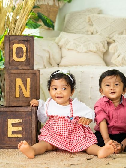 Another adorable shot of these two friends or siblings enjoying their joint birthday celebration in the studio.