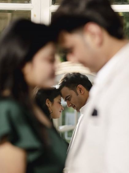 An artistic shot using reflections to create a layered and emotional portrait. This technique adds depth and a unique perspective to the couple's story.