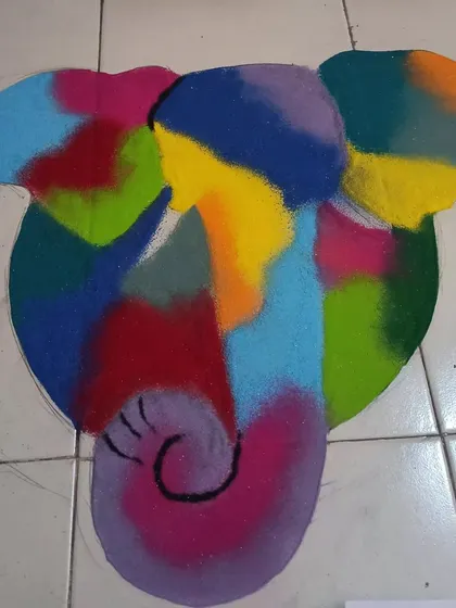 An abstract, multi-colored Ganesha rangoli. This style is perfect for those who want a modern and artistic take on traditional festive symbols.