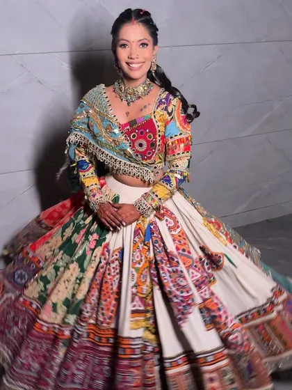 The joy of movement. Her colorful lehenga and festive makeup come to life as she twirls.