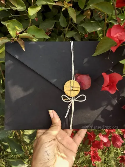 The presentation of a personal note is just as important as the words inside. This custom handwritten letter is enclosed in a simple black envelope, tied with twine and secured with a wooden button, creating a rustic and heartfelt first impression.