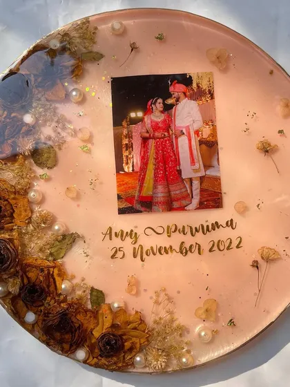 A 12-inch circular frame with a 2D effect, preserving a couple's varmala and photo in a simple and elegant design.