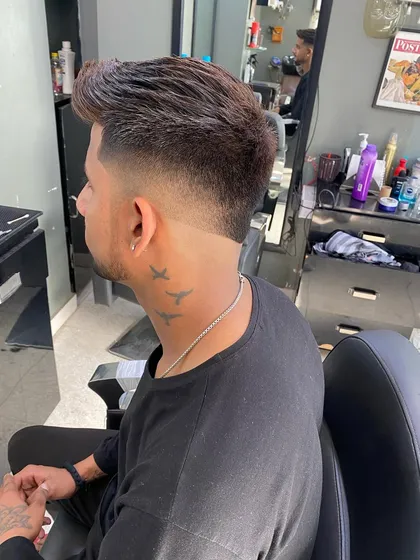 A classic taper fade on a client. This style is perfect for a professional look, keeping the sides neat while leaving some length on top.