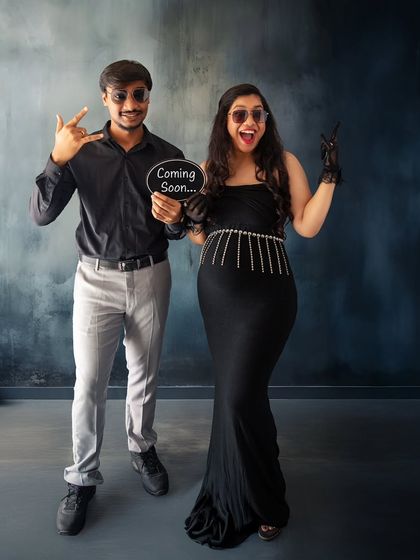 Rocking into parenthood. This fun and edgy "Coming Soon" announcement shows the couple's playful personality with cool sunglasses and rock-on gestures.