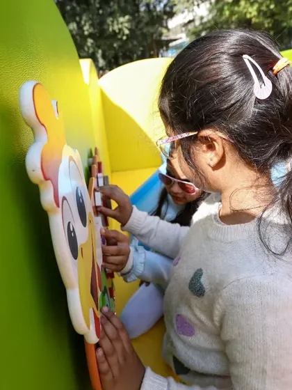Two friends exploring the engaging and educational activities on our sensory wall panels.