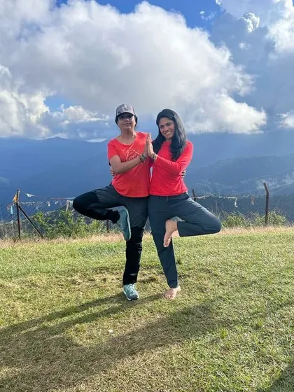 Finding stability and joy in a partner tree pose during our trek. Yoga can be practiced anywhere, anytime.