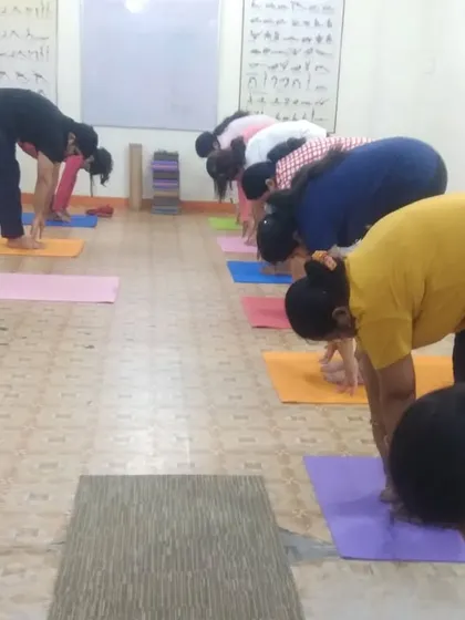 In this group session, students are practicing Uttanasana (Standing Forward Bend). We focus on releasing the lower back and stretching the hamstrings, a great way to decompress the spine after a long day.