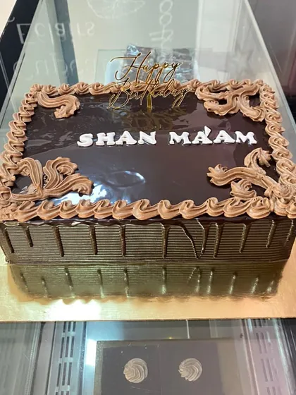 A classic rectangular chocolate truffle cake with a personalized birthday message.