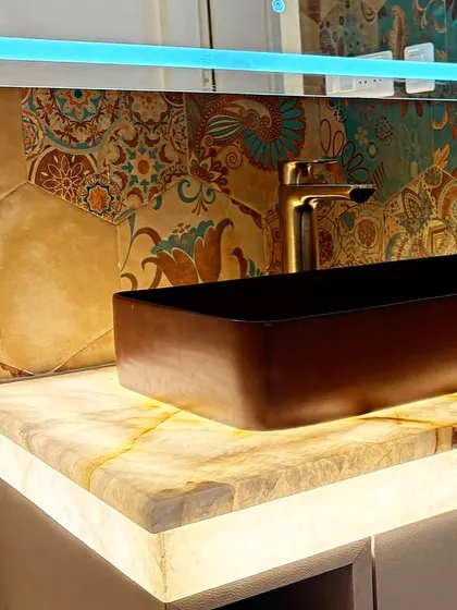 A close-up of the backlit onyx vanity counter from image 11.