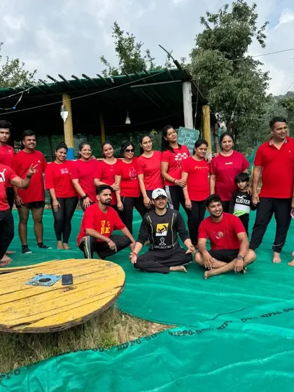 A group photo after a successful yoga retreat. The smiles and relaxed postures show the positive impact of taking time for wellness and team bonding.