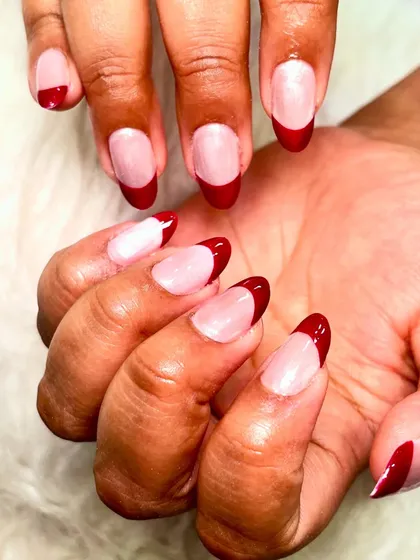 Another look at the fierce red chrome French tips, showing off the sharp almond shape and the high-gloss finish.