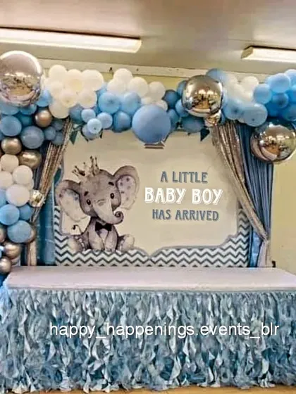 Welcoming a little one with our adorable elephant-themed decor. This setup features a full backdrop announcing "A Little Baby Boy Has Arrived," framed by a beautiful balloon arch in shades of blue, white, and silver, perfect for a joyful baby welcome party.