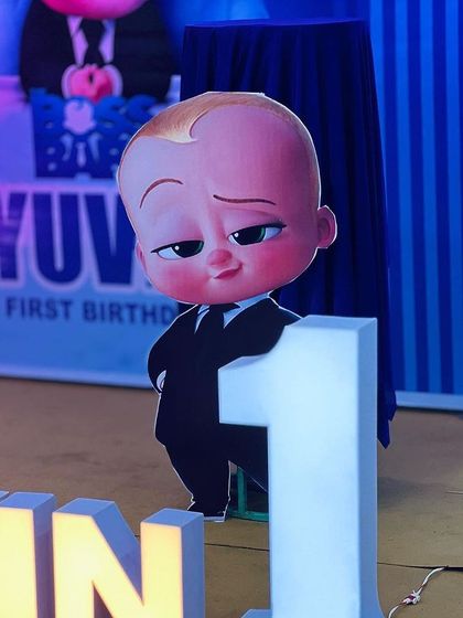 A close-up of the main Boss Baby cutout standing next to a large number '1', perfect for capturing those memorable first birthday photos.